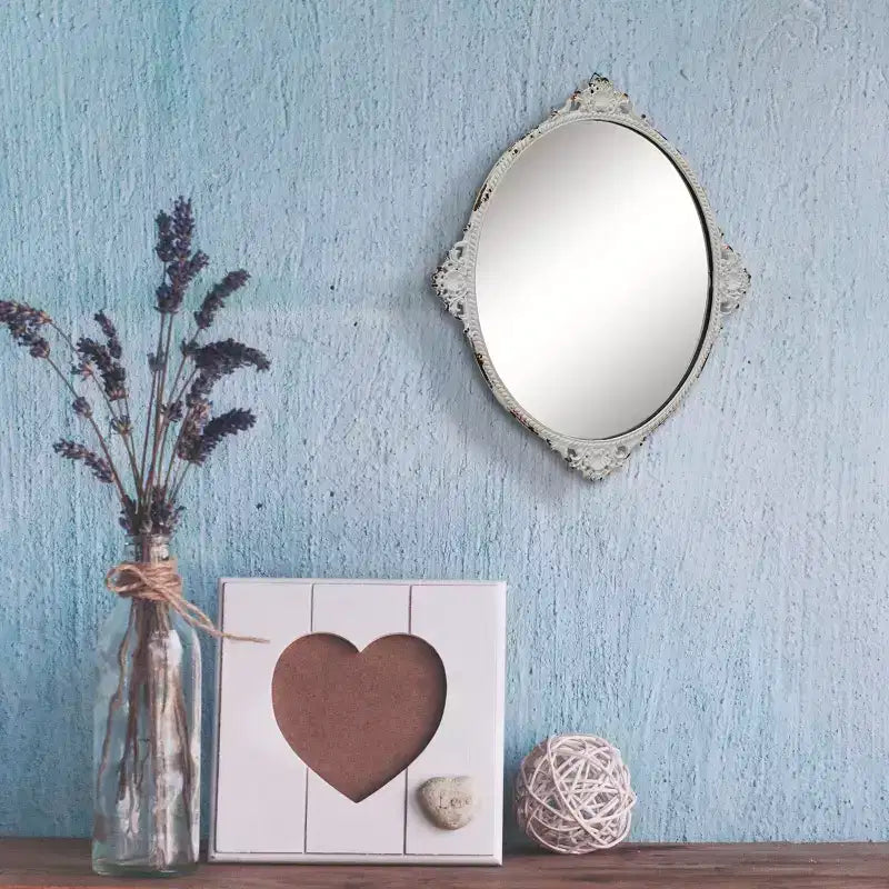 Miroir mural ovale en métal antique